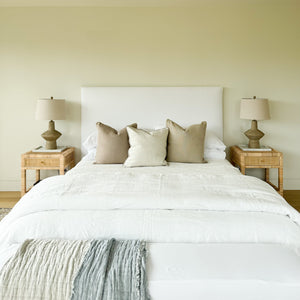 Upholstered bed with white fabric