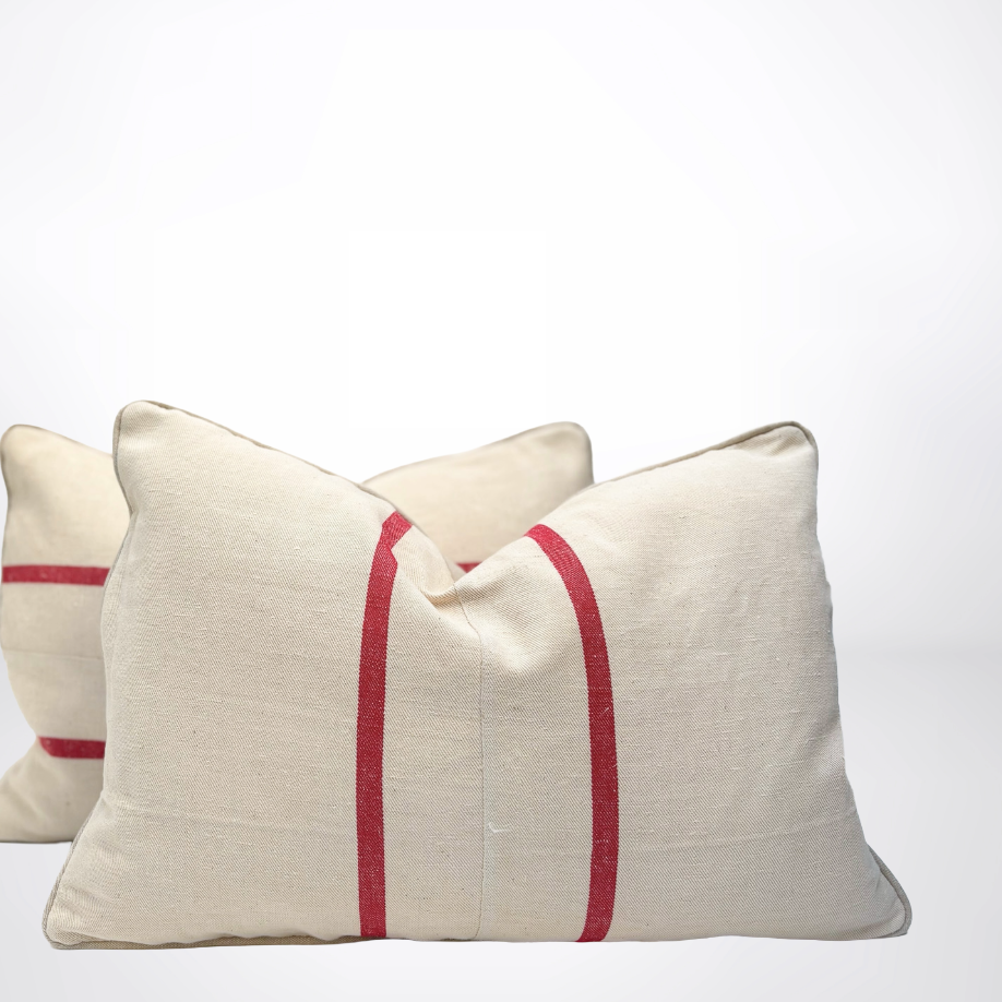 Two beige pillows with red stripes on a white background