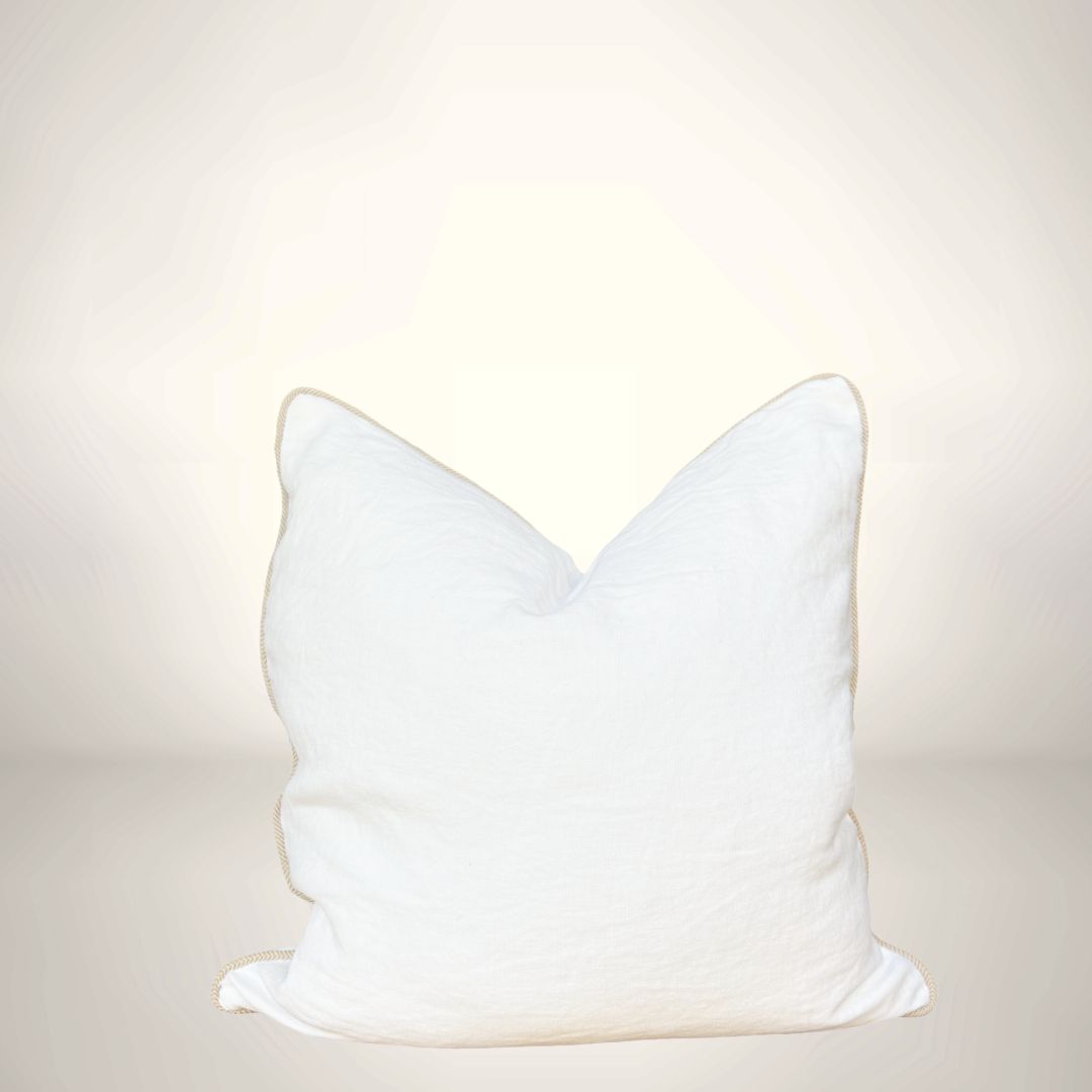 White cat-shaped pillow on a light beige background