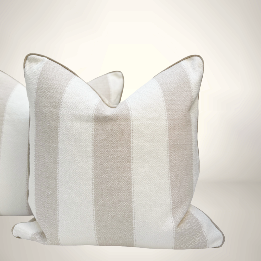 Striped pillow with beige and white pattern on a light background