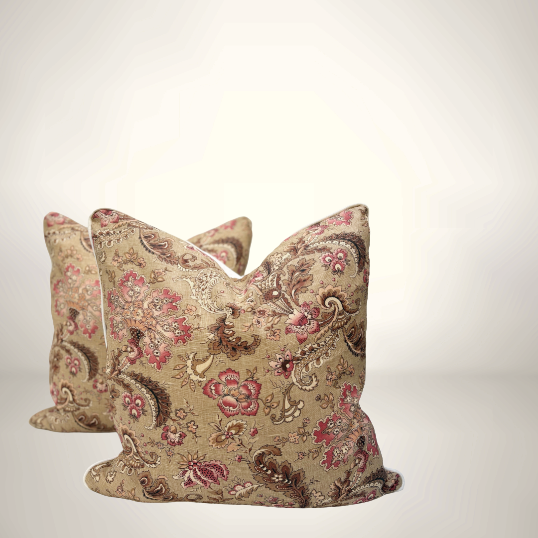 Decorative pillows with floral and paisley patterns on a light background