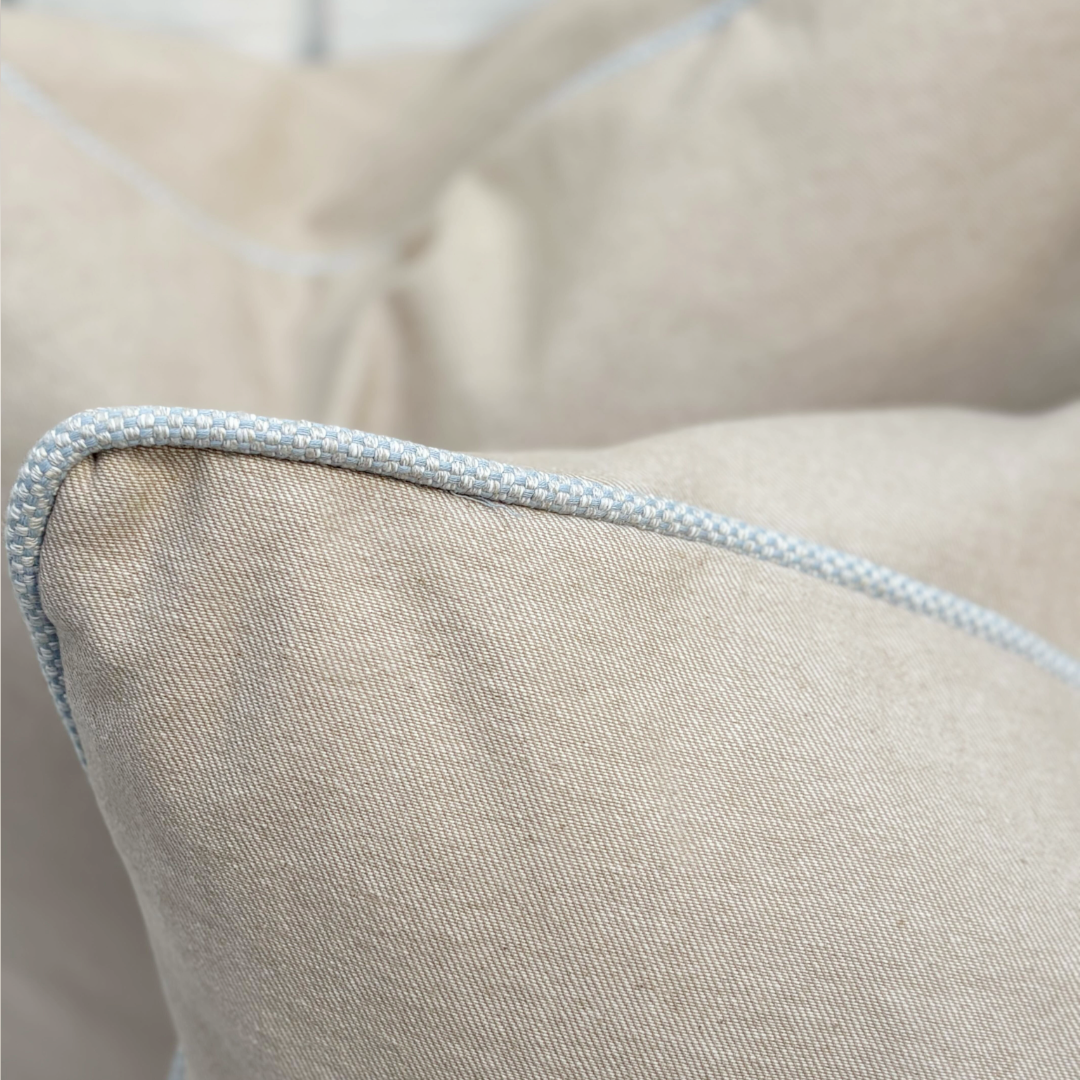Close-up of a beige pillow with a textured edge