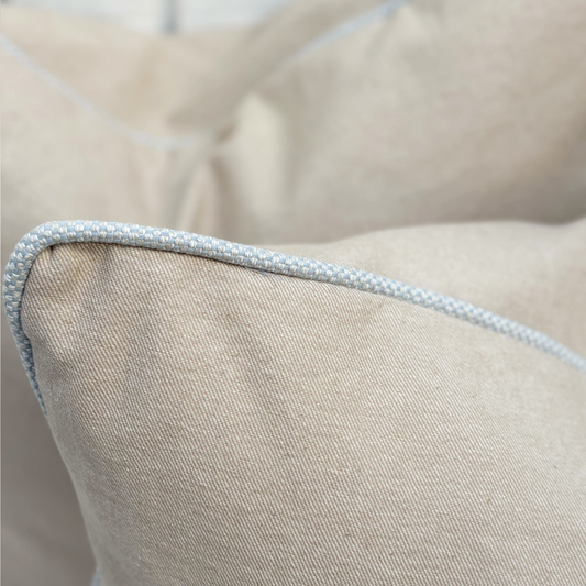 Close-up of a beige pillow with a textured edge
