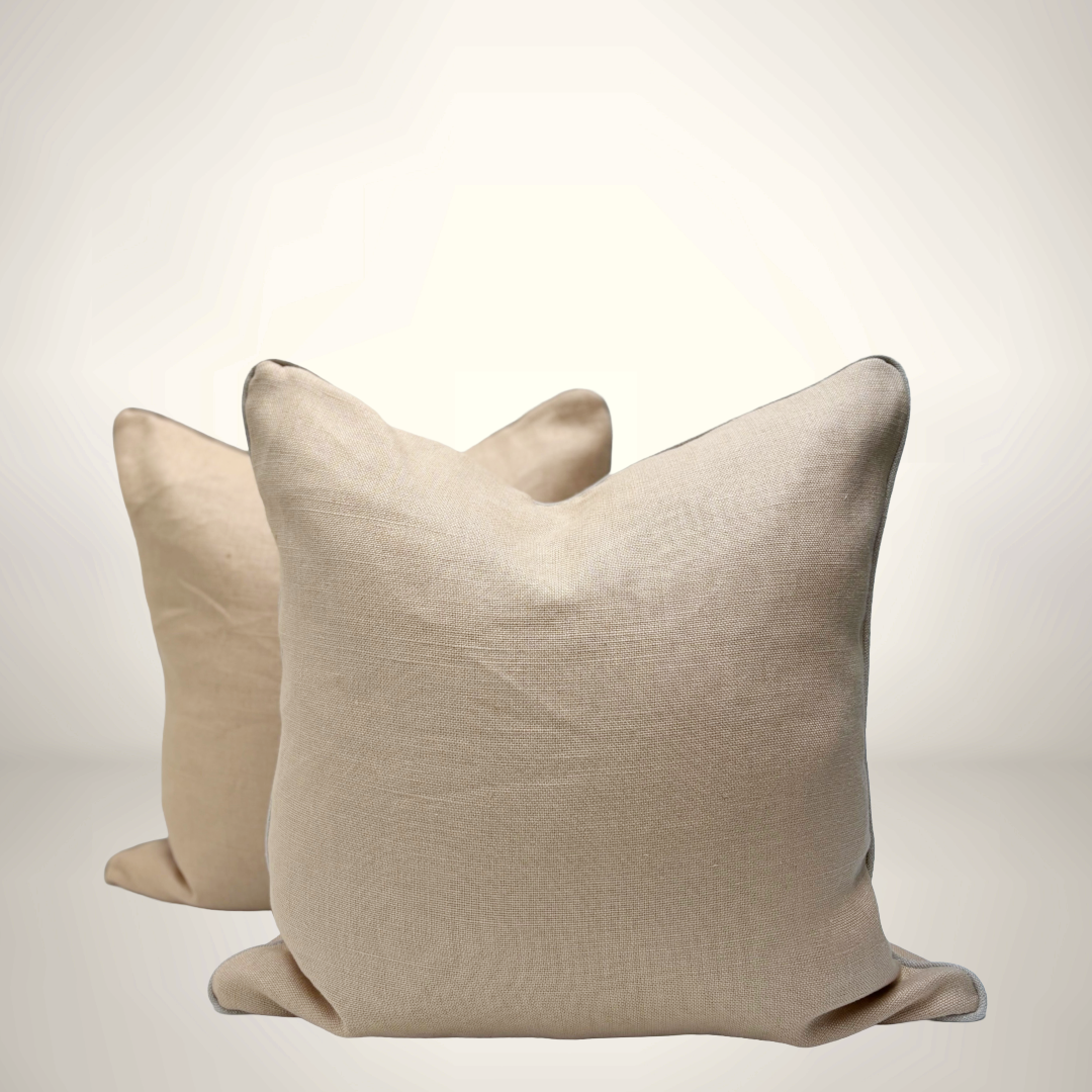 Two beige pillows on a light gray background