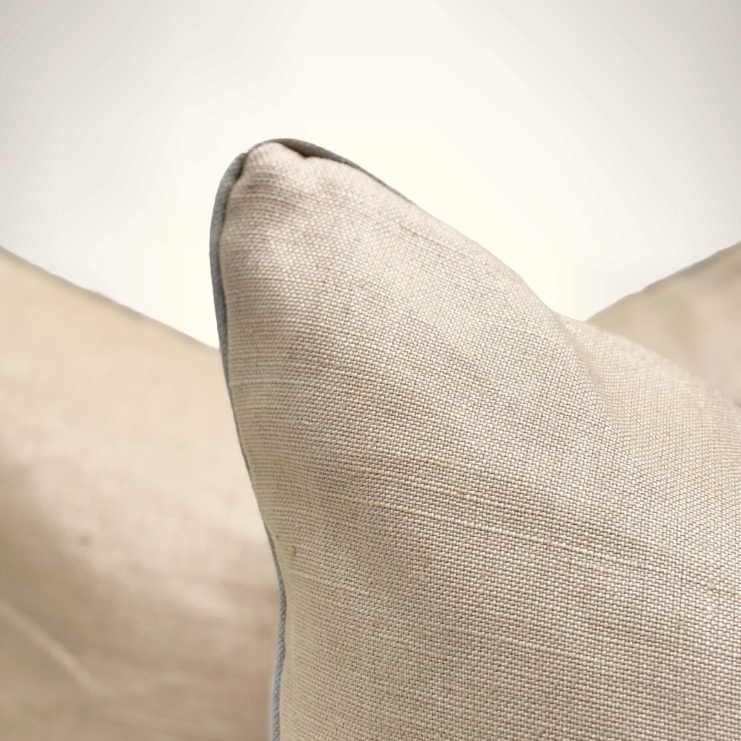 Close-up of a textured beige pillow on a neutral background