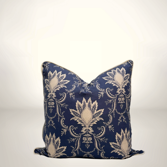 Decorative pillow with a blue and white pattern on a light gray background