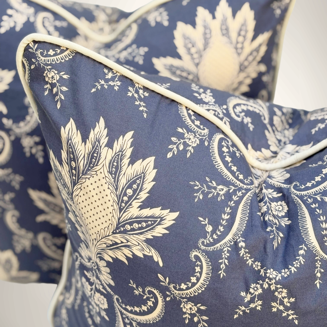 Blue and white patterned pillows on a bed