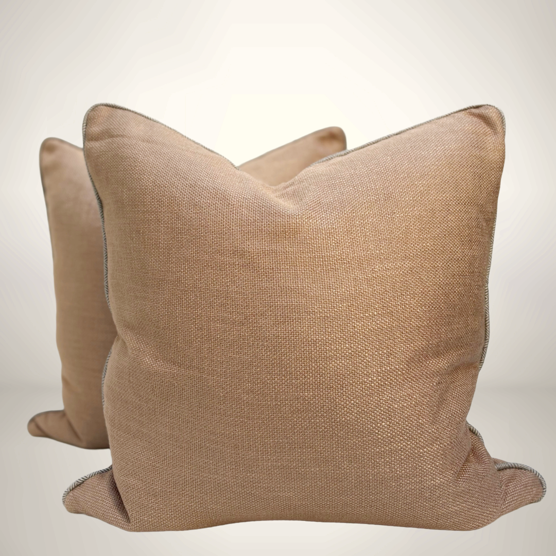 Two beige textured pillows on a light gray background