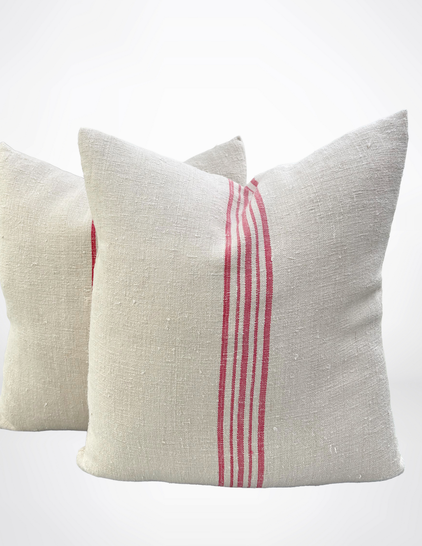 Two pillows with red stripes on a white background