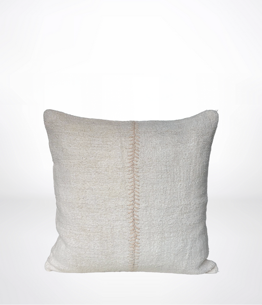 A square throw pillow in a textured off-white linen fabric, featuring a vertical decorative hand-stitched seam down the center, set against a plain white background.