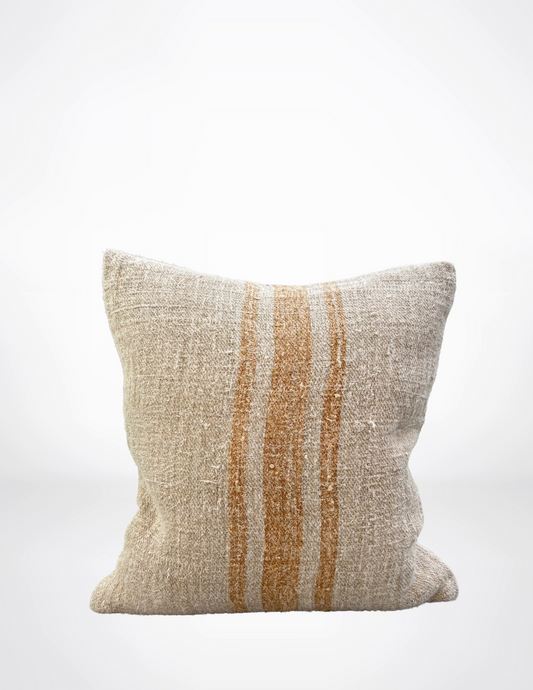 Textured pillow with brown stripes on a white background