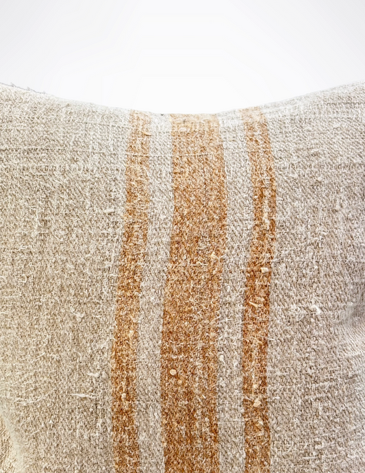 Textured pillow with brown and beige stripes on a white background