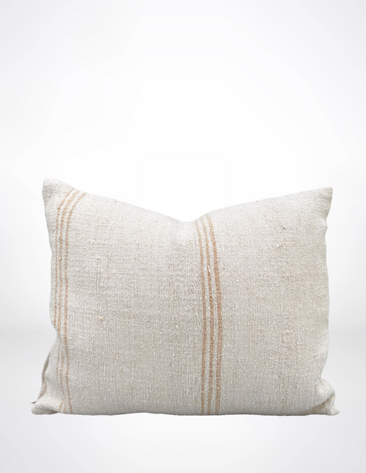 Textured pillow with two gold stripes on a white background