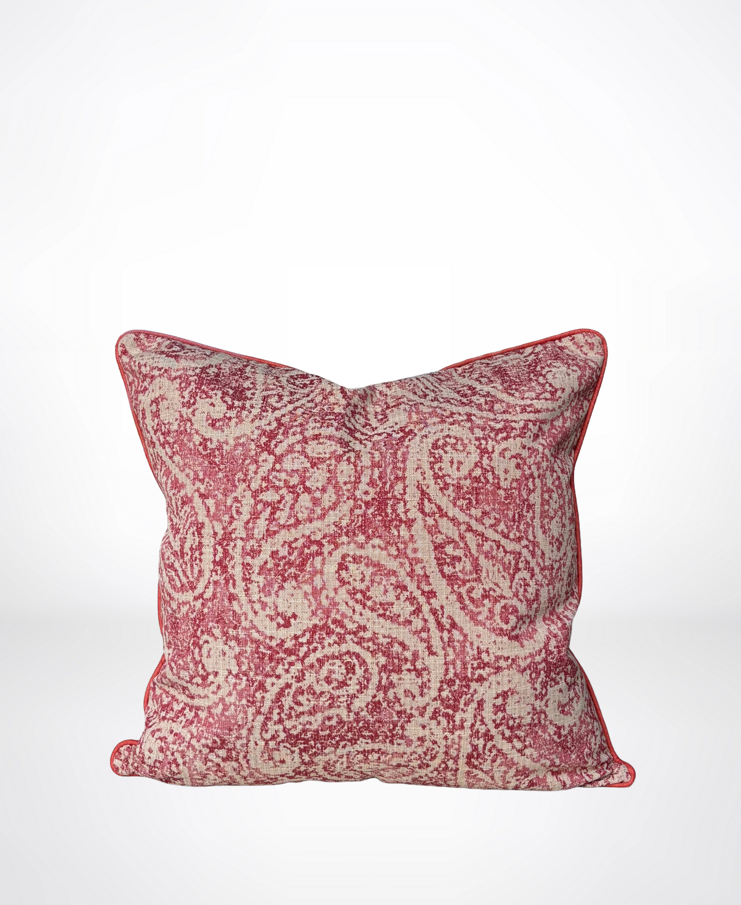 A square decorative throw pillow featuring a distressed red and beige paisley pattern with a red piped edge, shown against a clean white background.