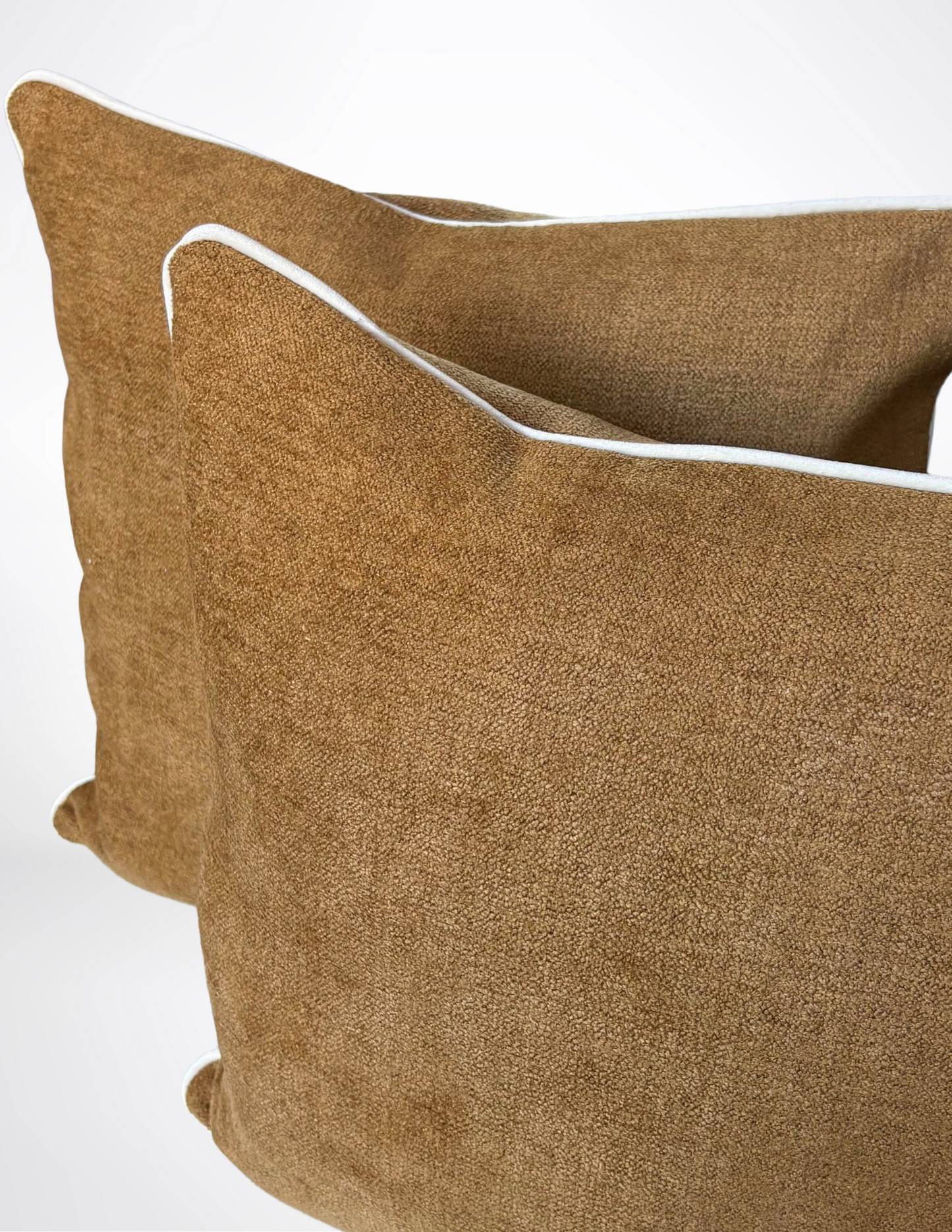 brown pillows with white piping