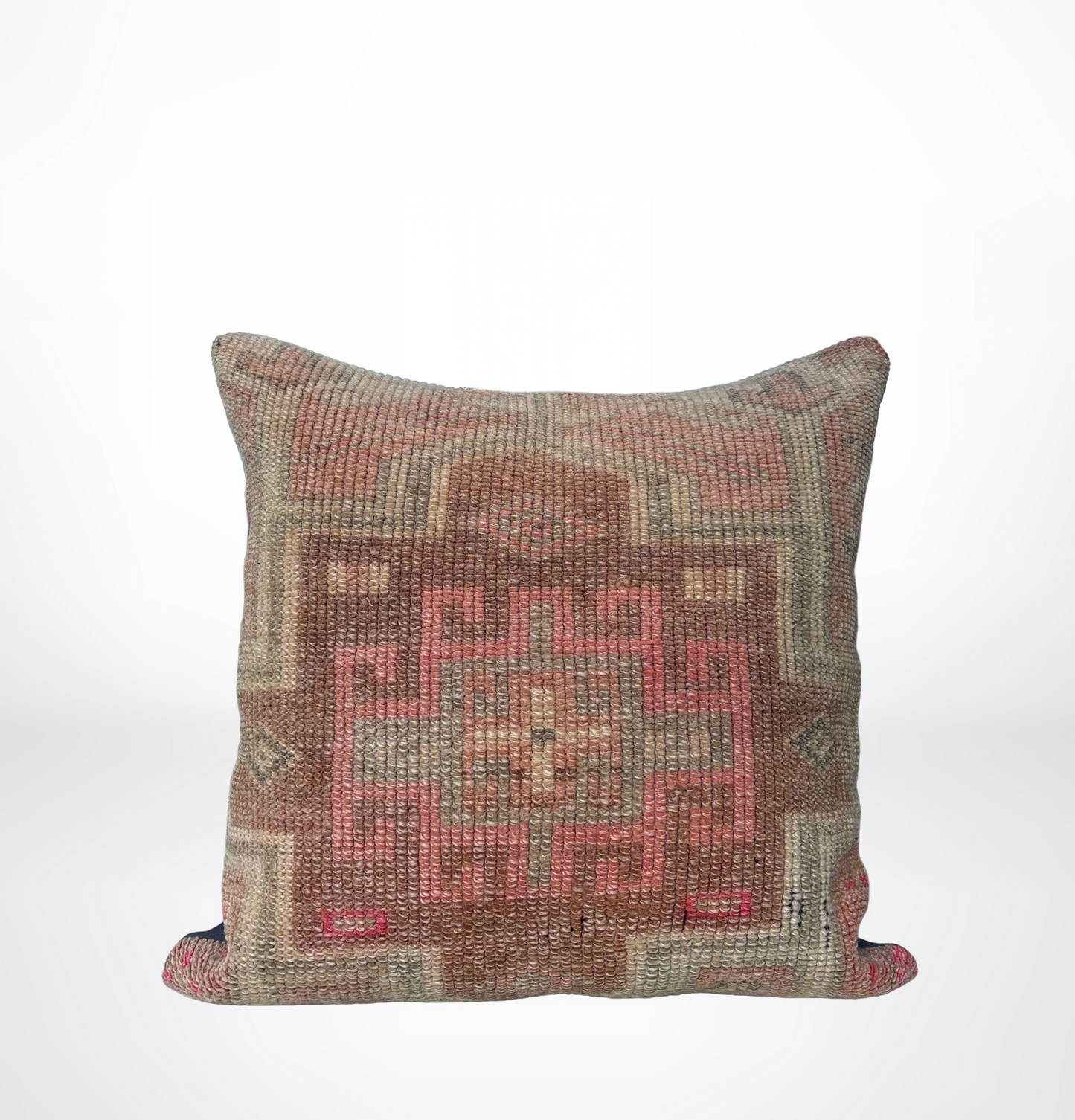 A square throw pillow featuring a distressed, vintage-style kilim pattern in muted shades of terracotta, dusty pink, beige, and brown, set against a clean white background.