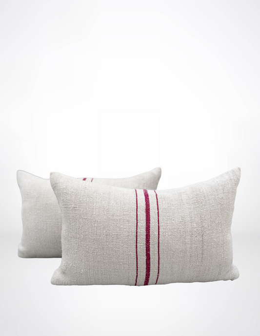 Two textured pillows with a red stripe on a white background