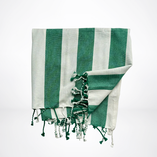 Green and white striped towel with tassels on a light gray background