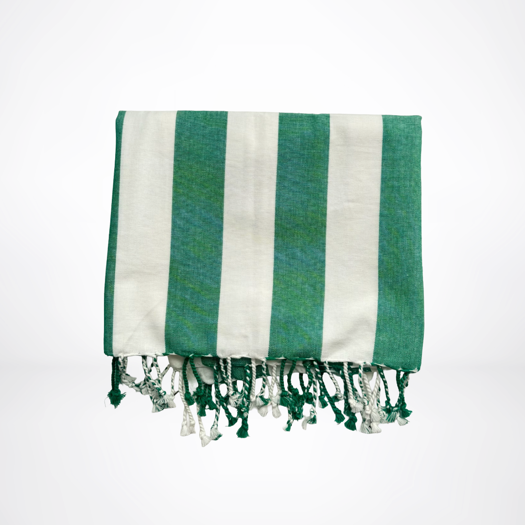 Green and white striped towel with fringes on a white background