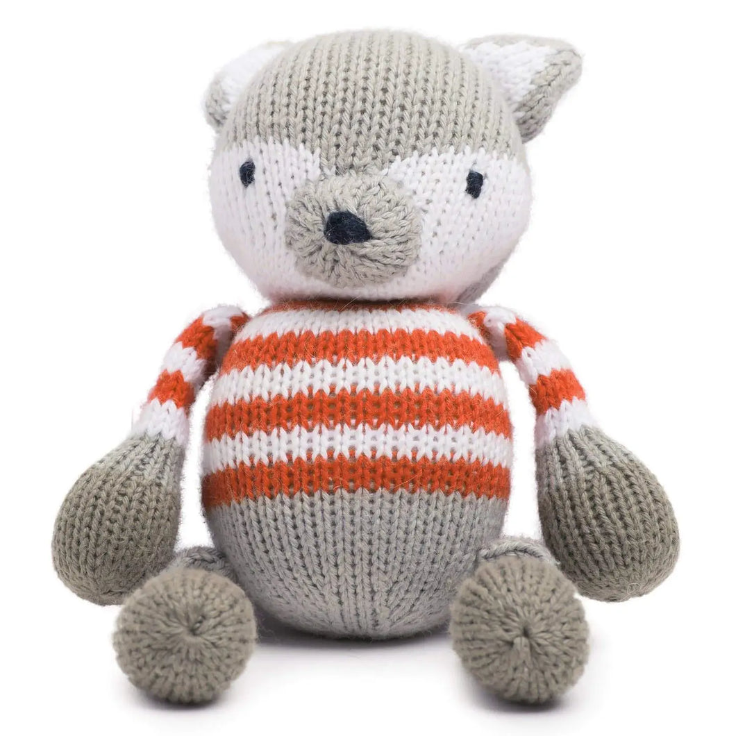 Knitted toy fox with a striped body on a white background