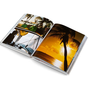 Open photo album showing a sunset and palm tree scene