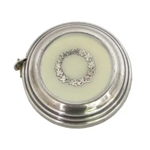 silver measuring tape with cream top with aged gold wreath like pattern