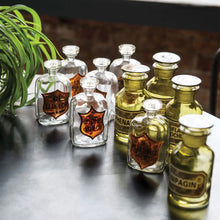 Load image into Gallery viewer, Set of green apothecary jars with lids with vintage inspired labels