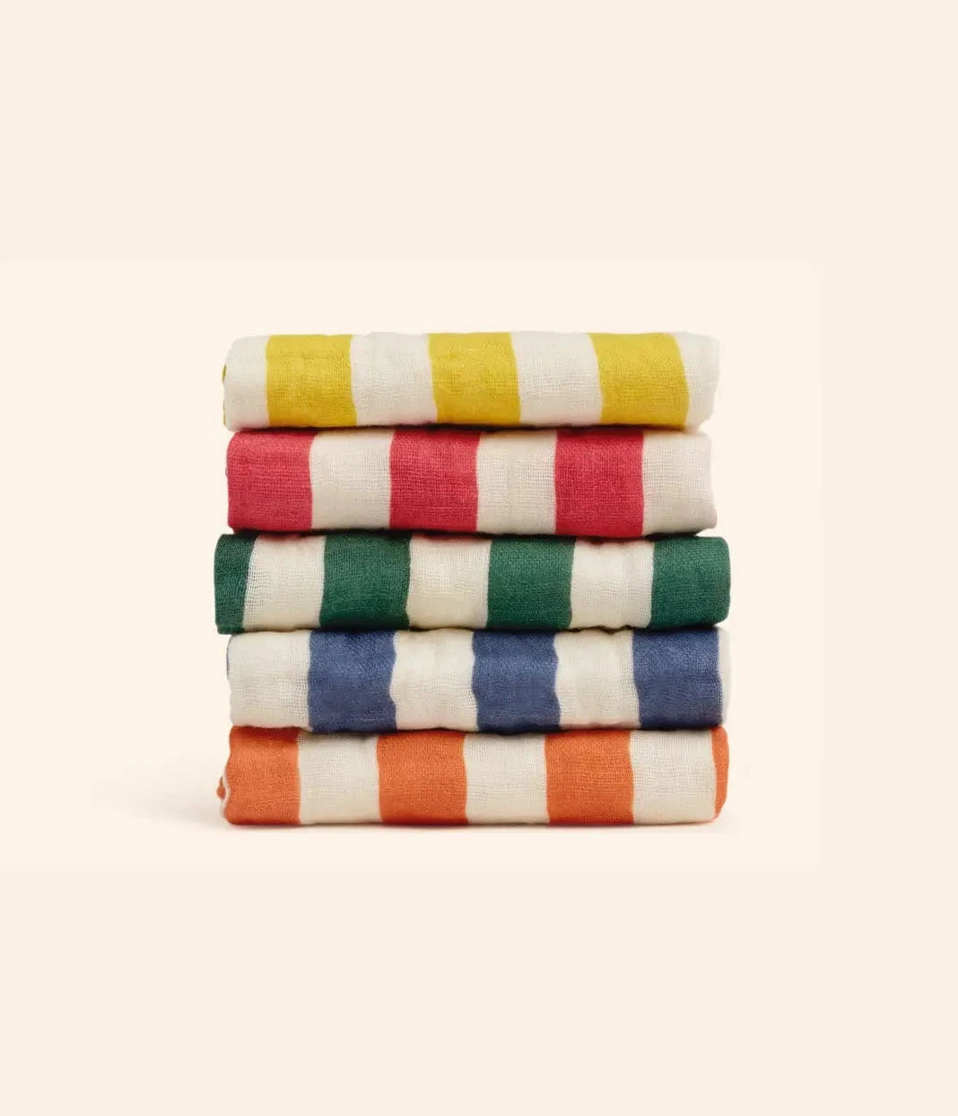 Stack of colorful striped towels on a beige background