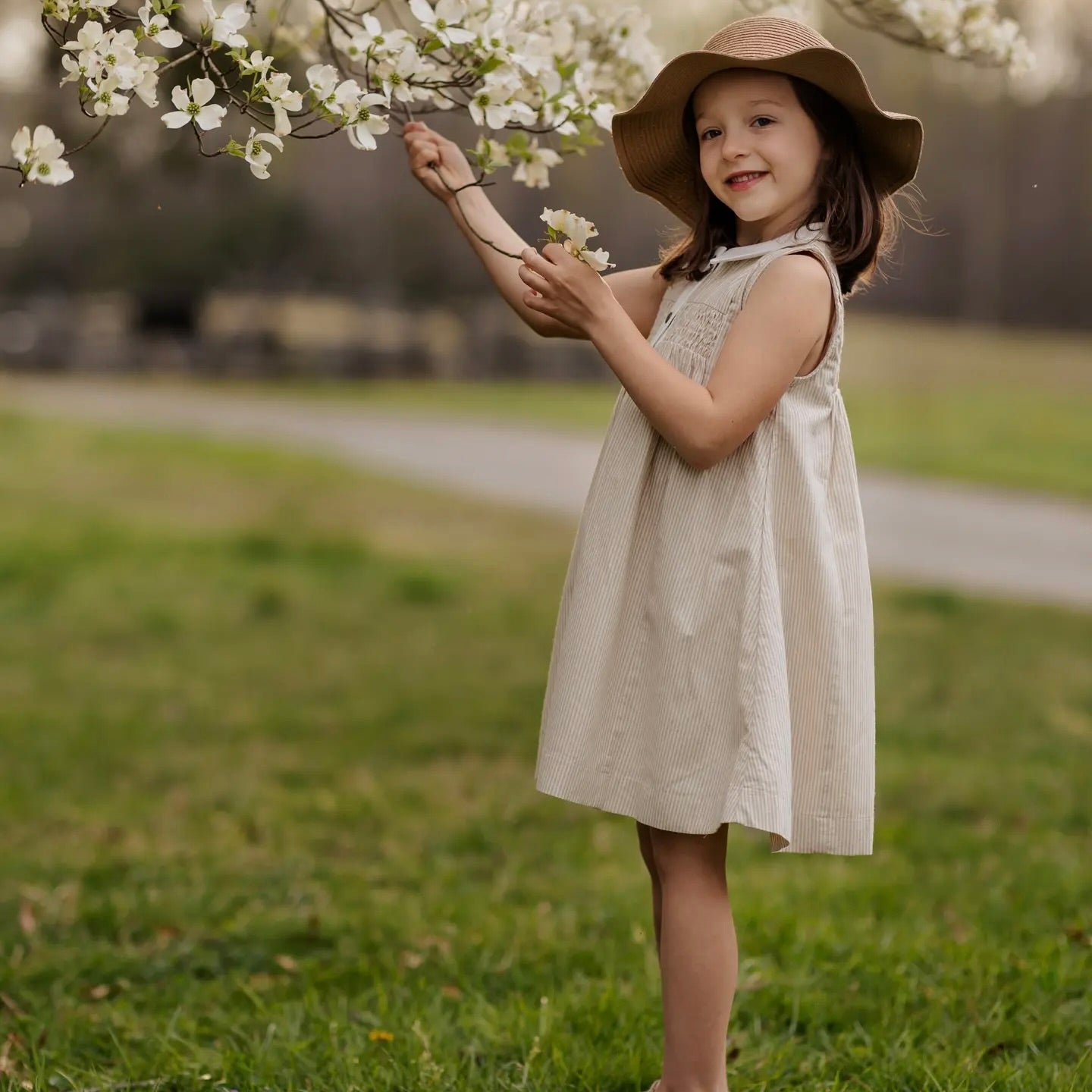 beige pinstripe kid's sleeveless dress with front snaps