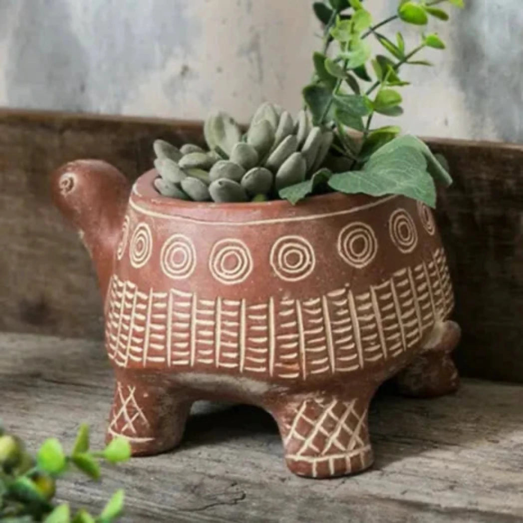 cement terra cotta colored planter shaped like turtle with cream colored pattern