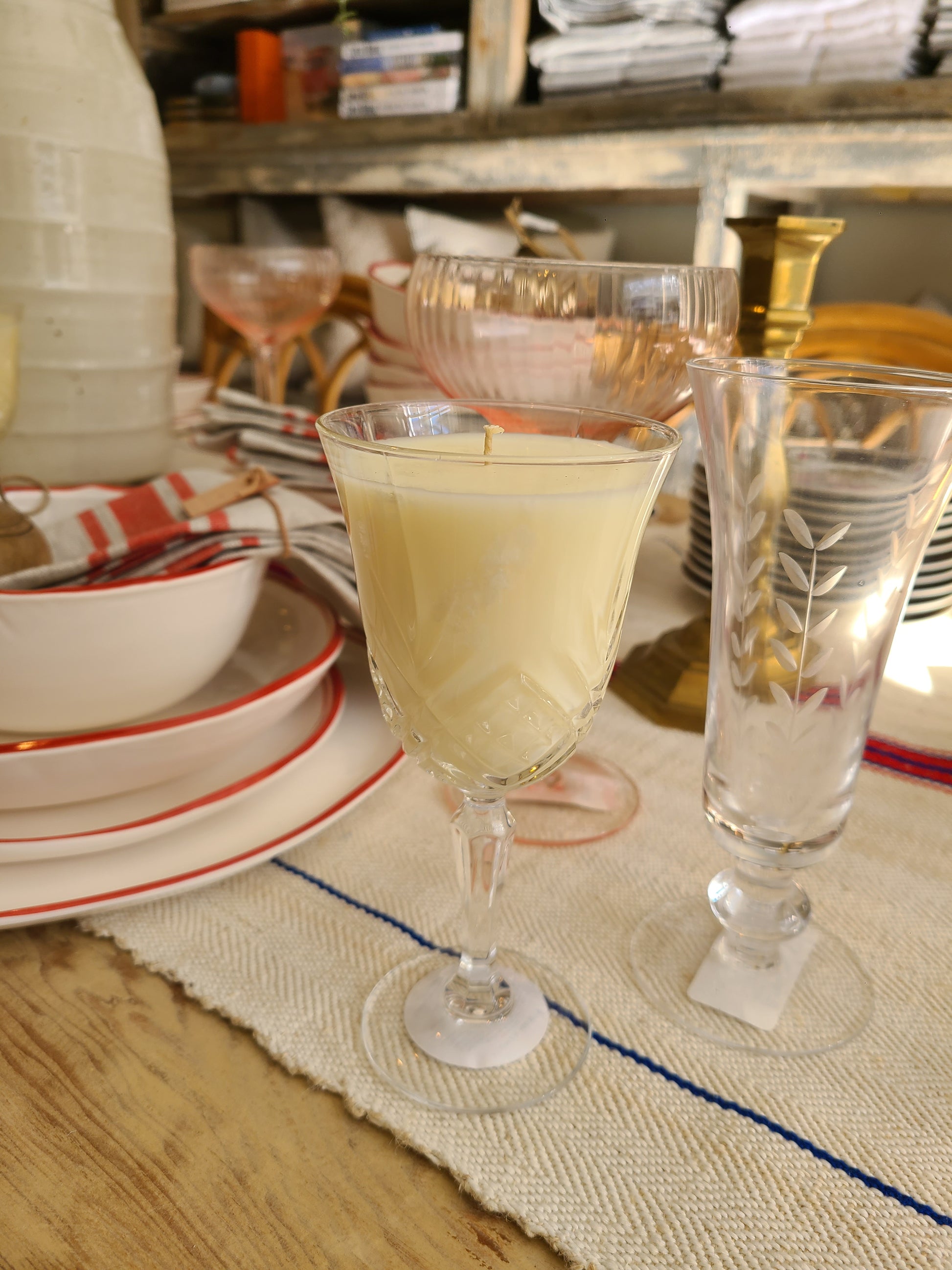 Glass with candle in it  on a wooden table with a blurred background