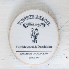 Load image into Gallery viewer, white round wood drink coaster with black Tumbleweed and Dandelion logo