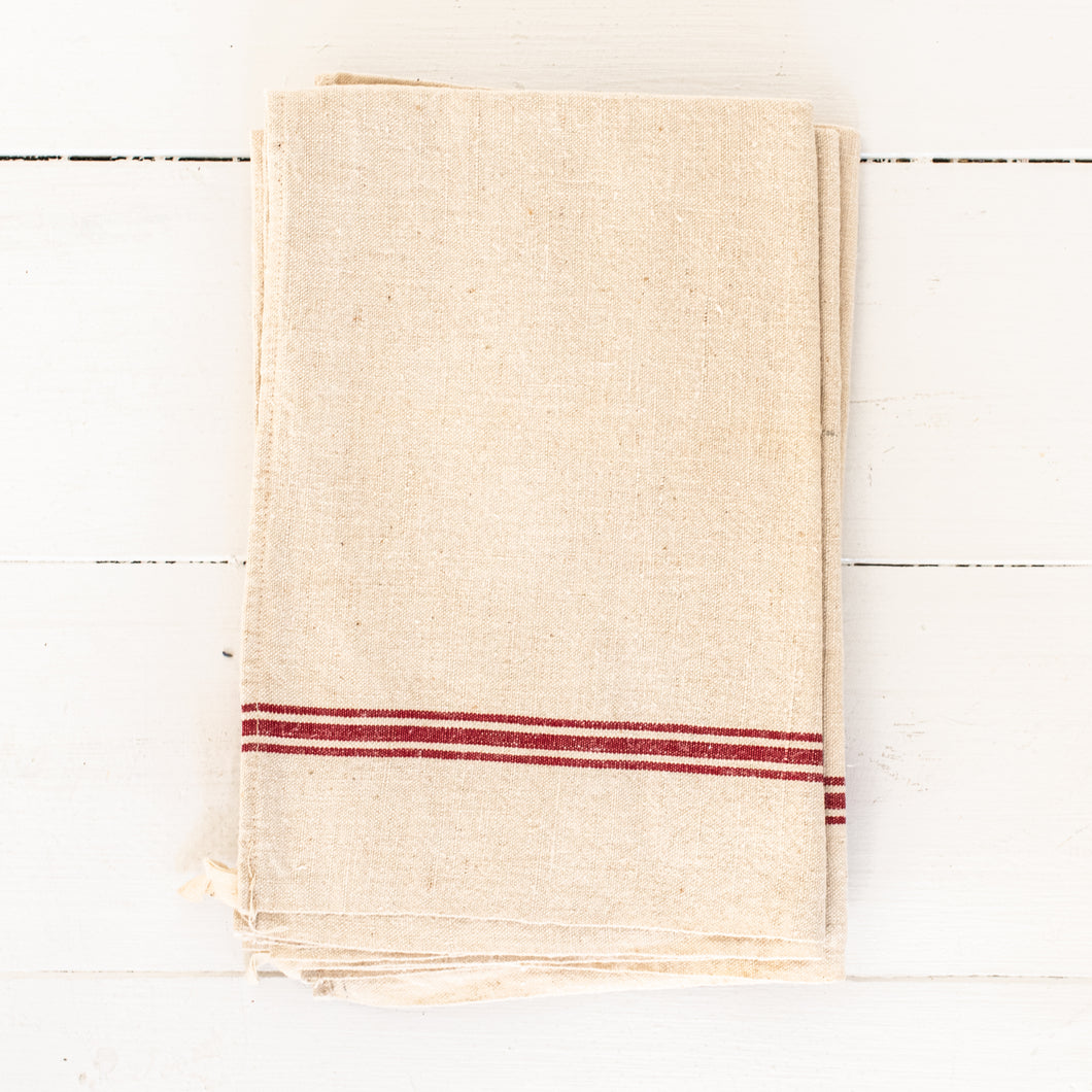 cream colored linen dishtowel with red stripes
