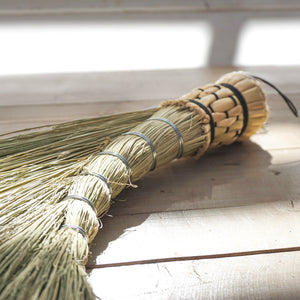 Small hand held broom in sage green