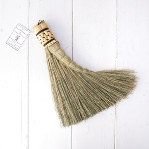Small hand held broom in sage green