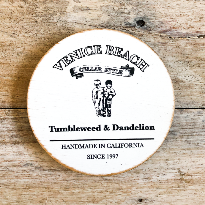 Recycled round wood coaster with Venice Beach text and Tumbleweed and Dandelion logo 