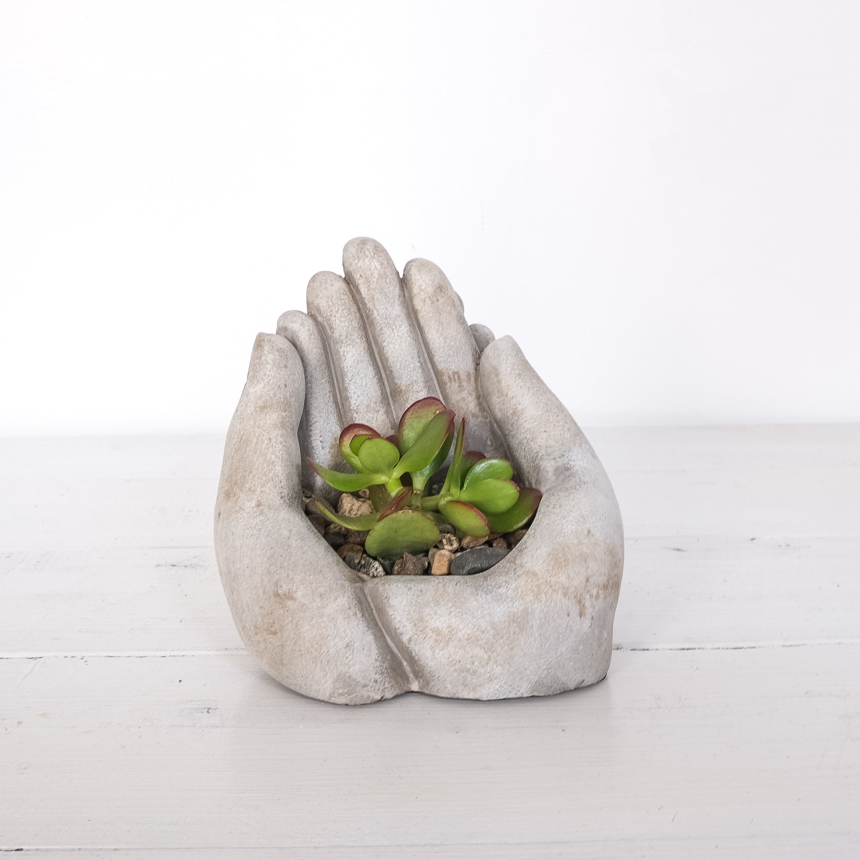 two stone hands together shaped as a bowl