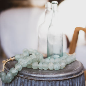 pale green glass beads on a strand of jute