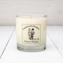 Load image into Gallery viewer, Clear glass candle with Tumbleweed and Dandelion logo, flowery scent