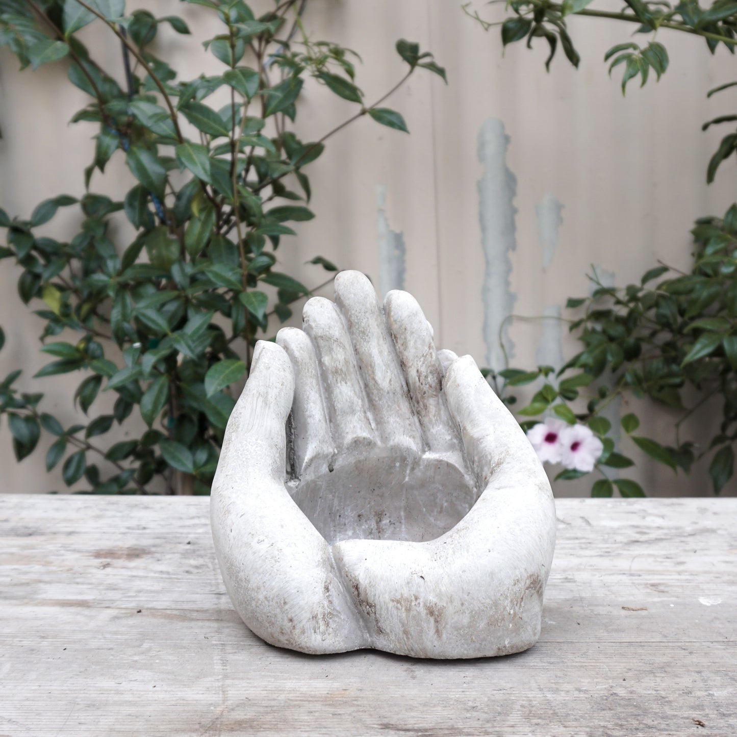 two stone hands together shaped as a bowl