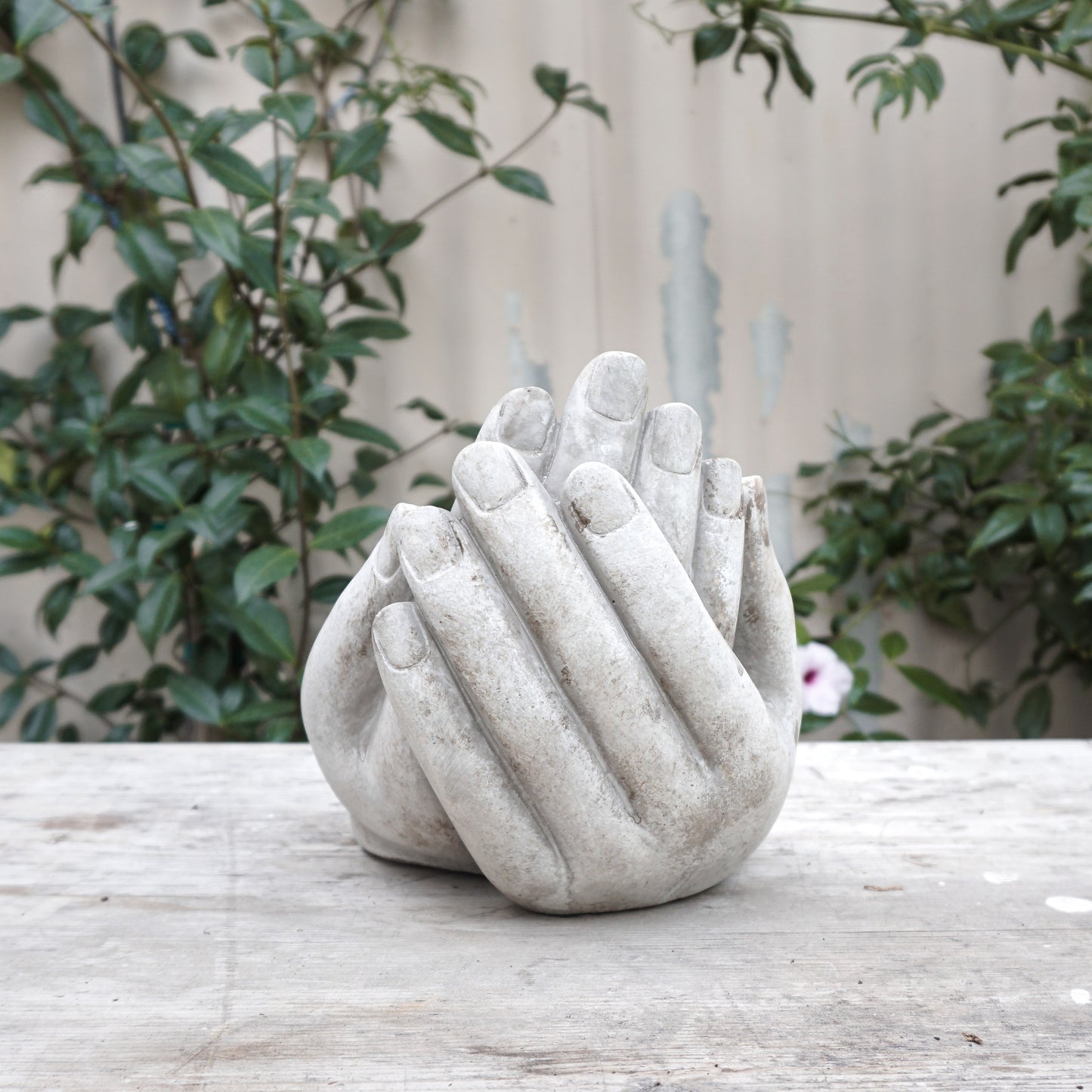 two stone hands together shaped as a bowl