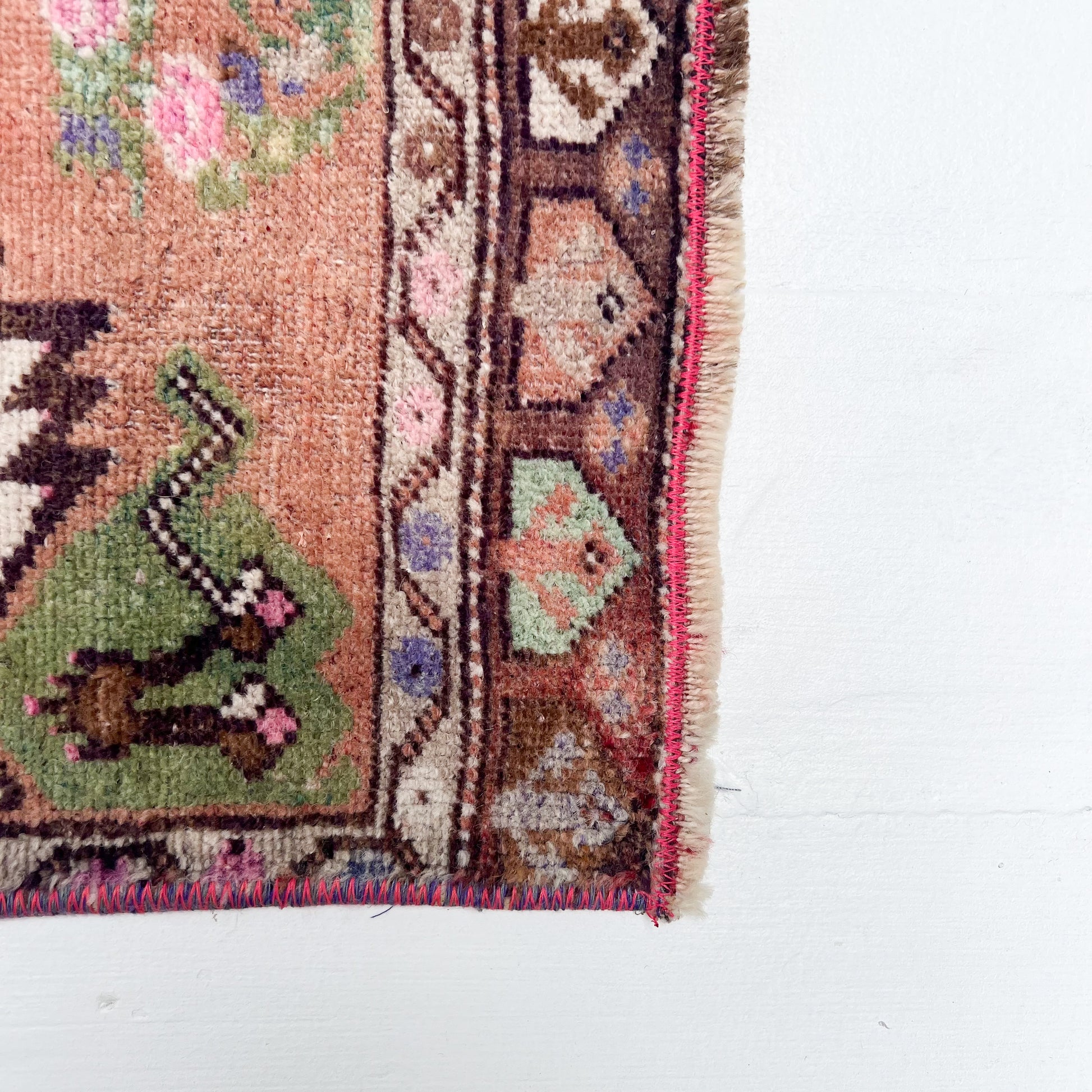 peach, green, brown, white and pink colored Turkish small rug