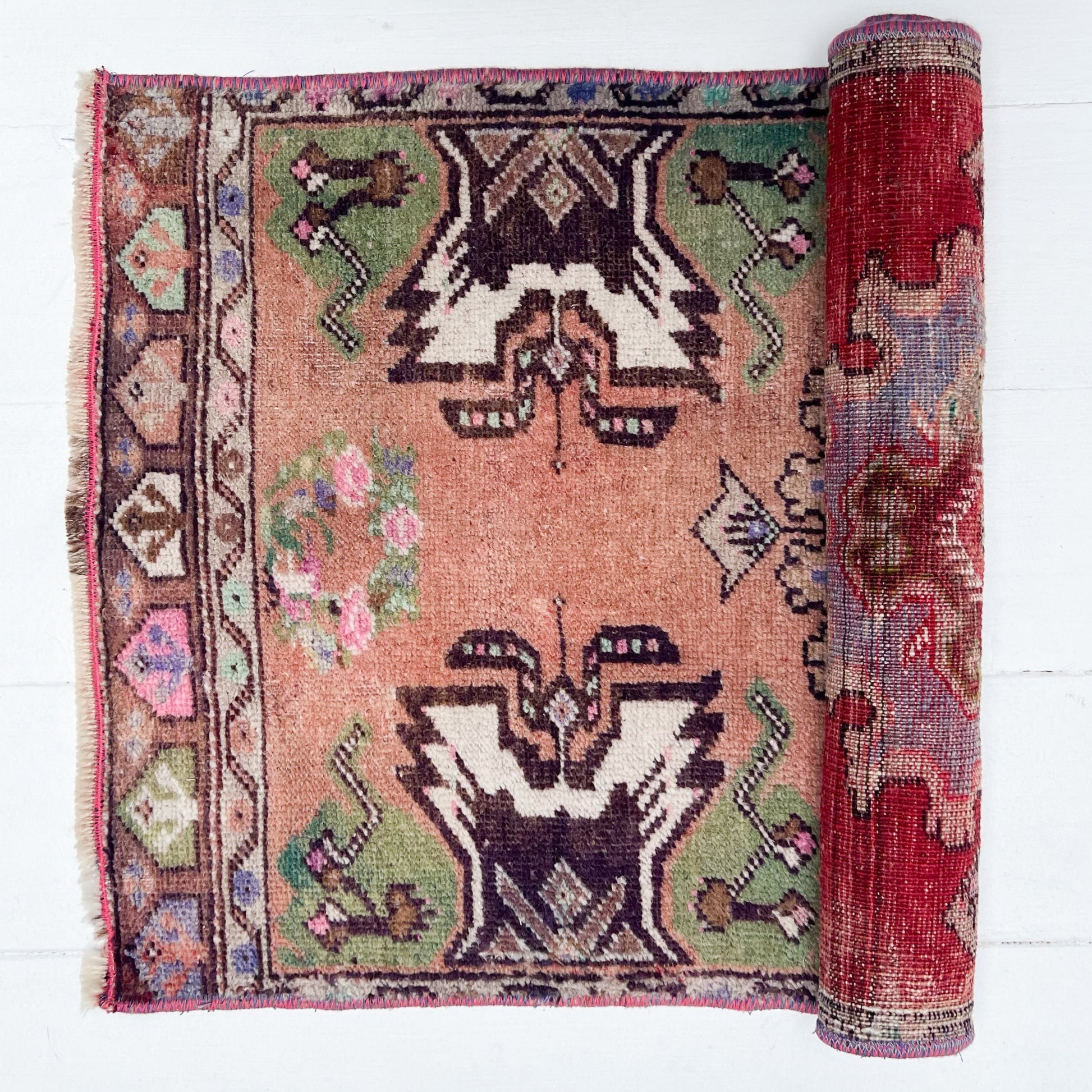 peach, green, brown, white and pink colored Turkish small rug