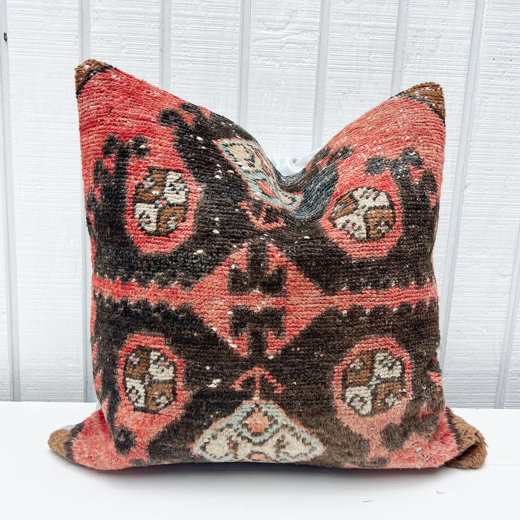 square pillow made from Turkish rug with salmon and black colors