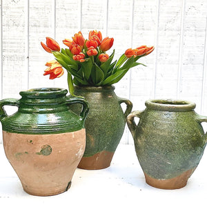green glazed terra cotta jugs with two handles on side