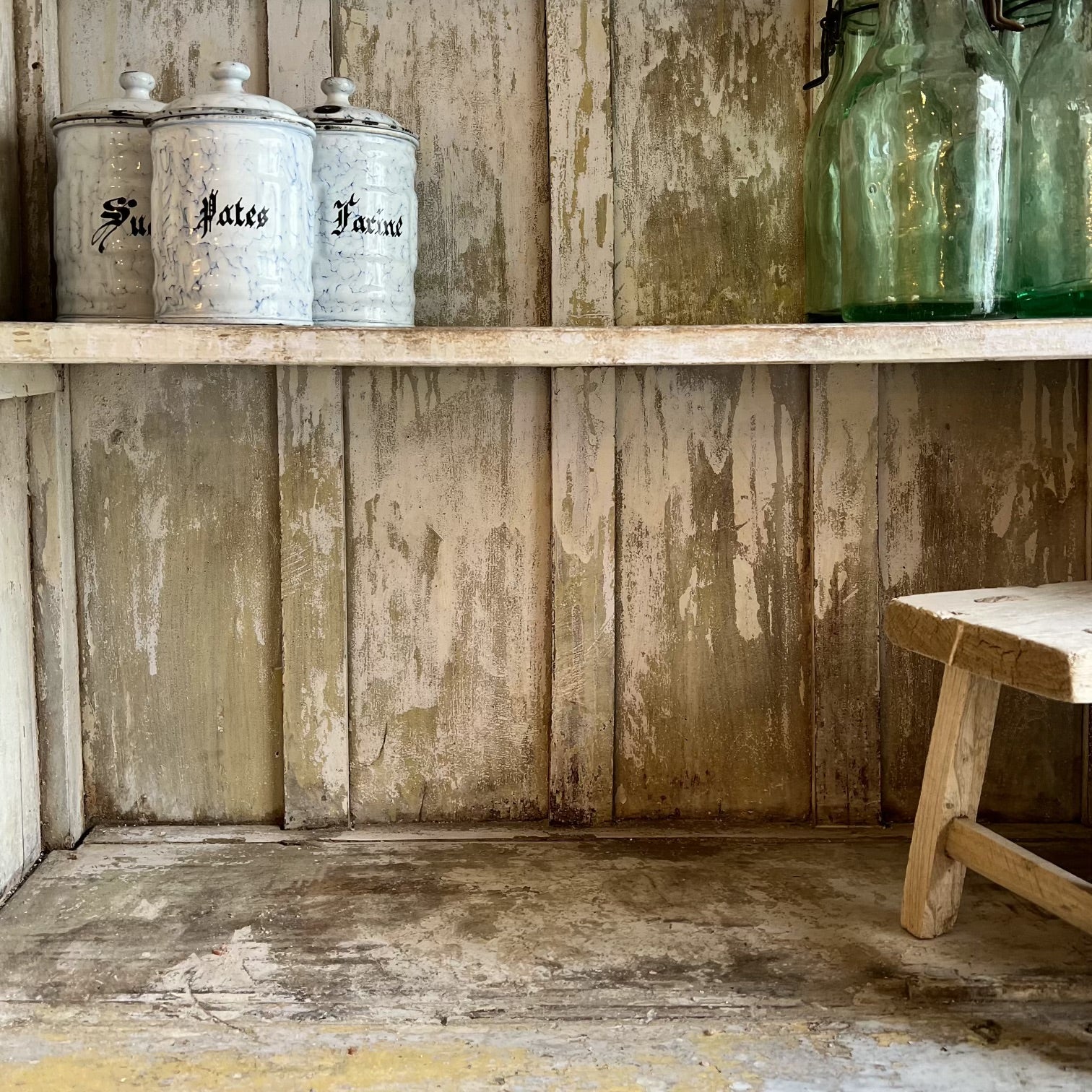 rustic hutch of old wood with distressed butter yellow paint finish, glass doors on top and  bottom