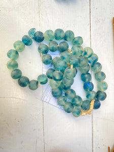 turquoise glass beads on a strand of jute