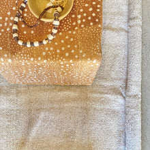 Load image into Gallery viewer, amber and white patterned mud cloth upholstered cube ottoman