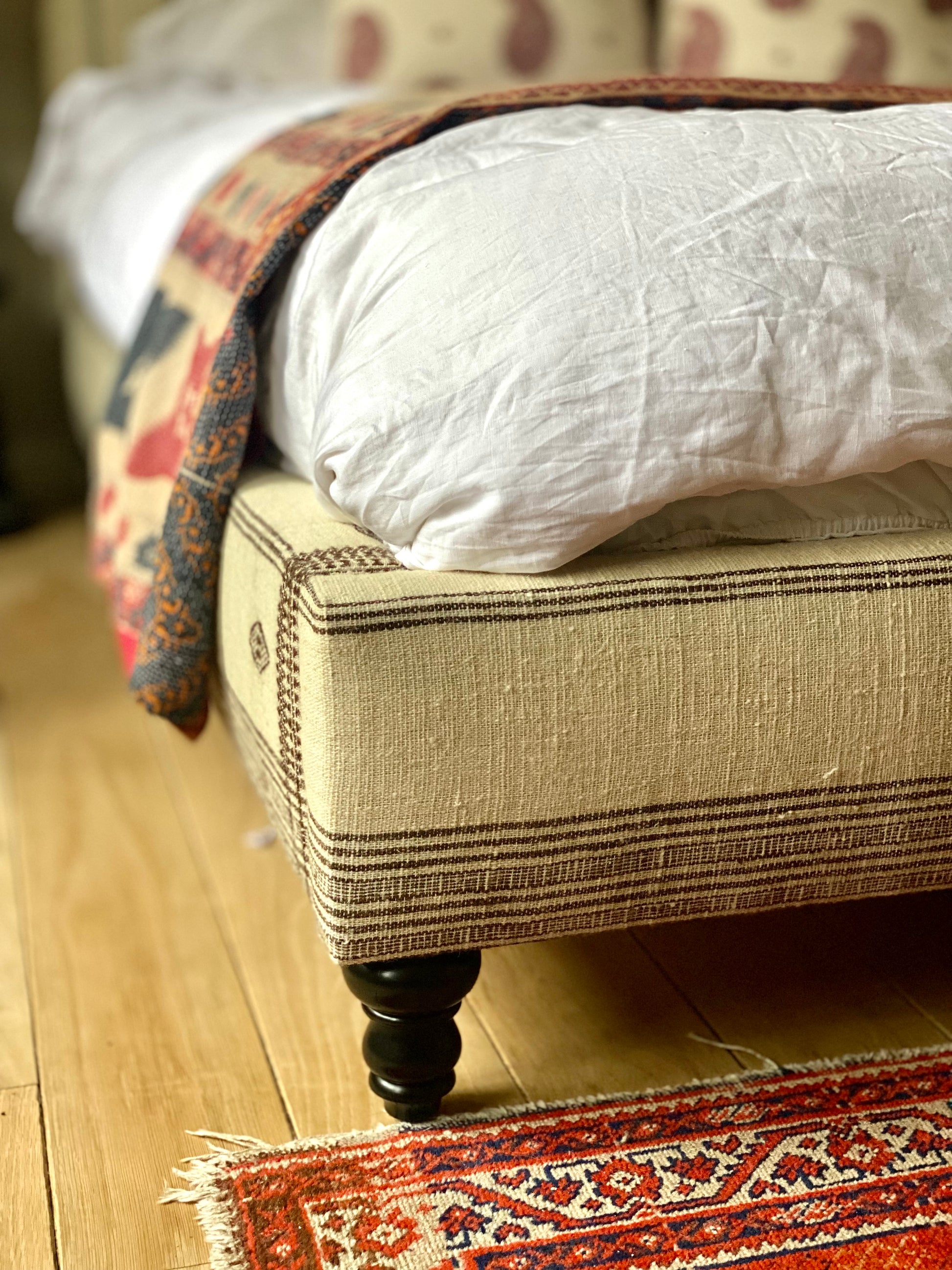 Indian Bhujodi cream and brown fabric upholstered bed with wood feet
