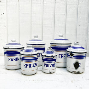 white enamel vintage spice jar set in varying sizes with blue trim and French text in blue